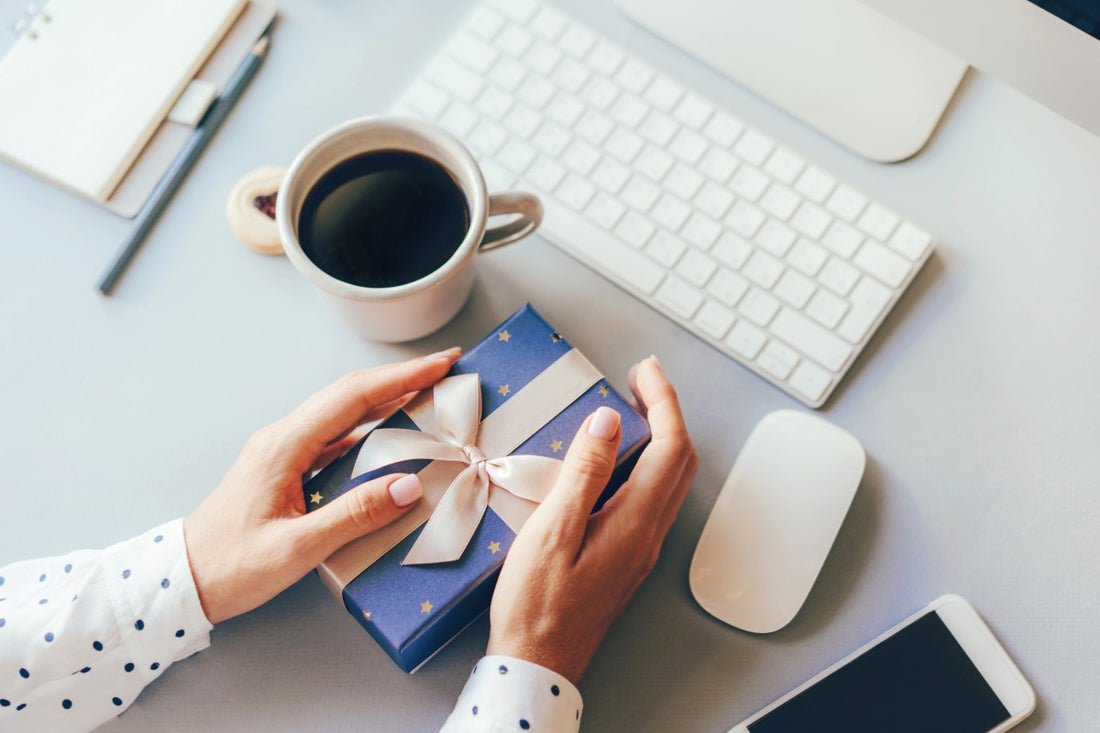 woman holding corporate gift at her desk